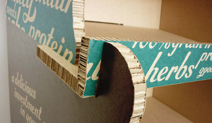 A close up of the edge of one of the display stand shelves showing the thick, corrugated board.