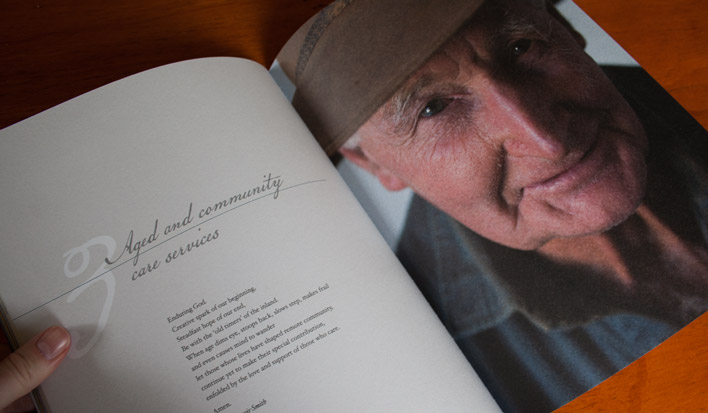A double page spread of a chapter start which includes the title in handwritten script and a prayer on the left page and on the right a full page portrait of an elderly man from the country.