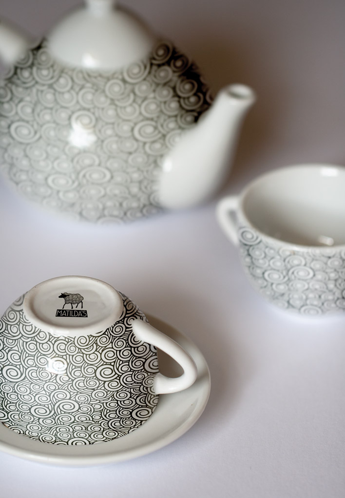 A tea-set for the Matilda's Tea House which uses the scrolling linework from the sheep of the Matilda's logo on crisp, white china.